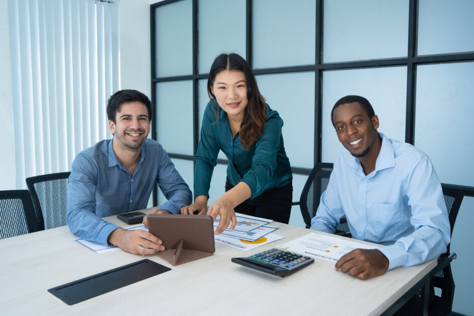 Three smiling mix raced professionals discussing new project